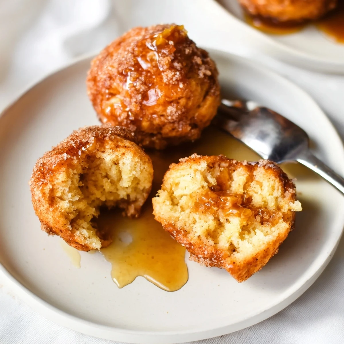 Tender Maple Ginger Cheddar Cinnamon Sugar Biscuit Muffin Balls drizzled with sweet syrup.