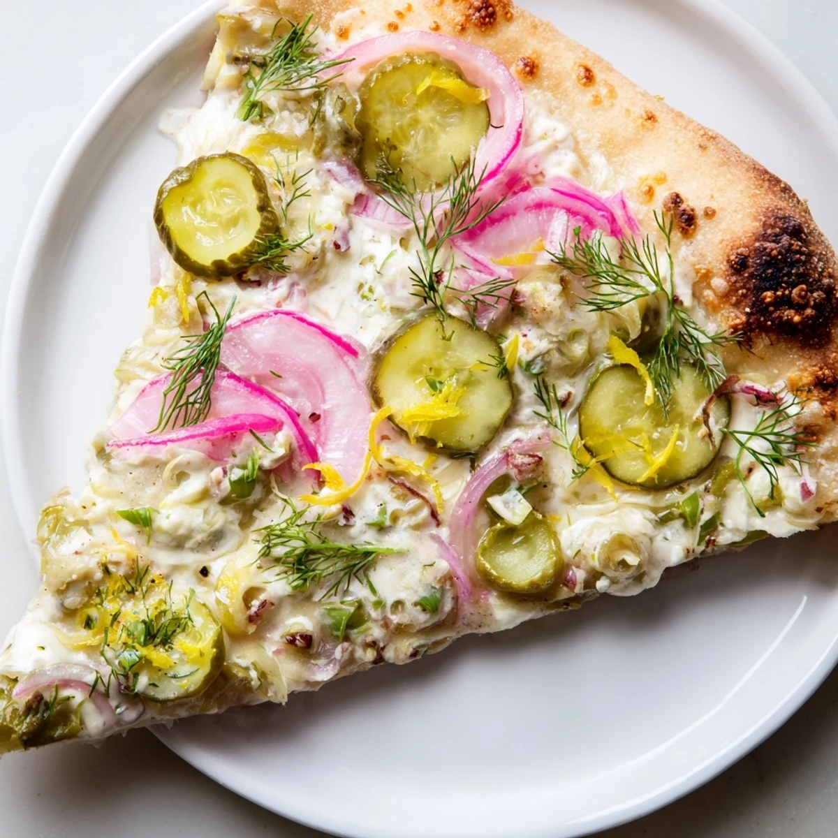 Tangy Pickle Pizza from the oven, featuring melted mozzarella and fresh garnishes.  