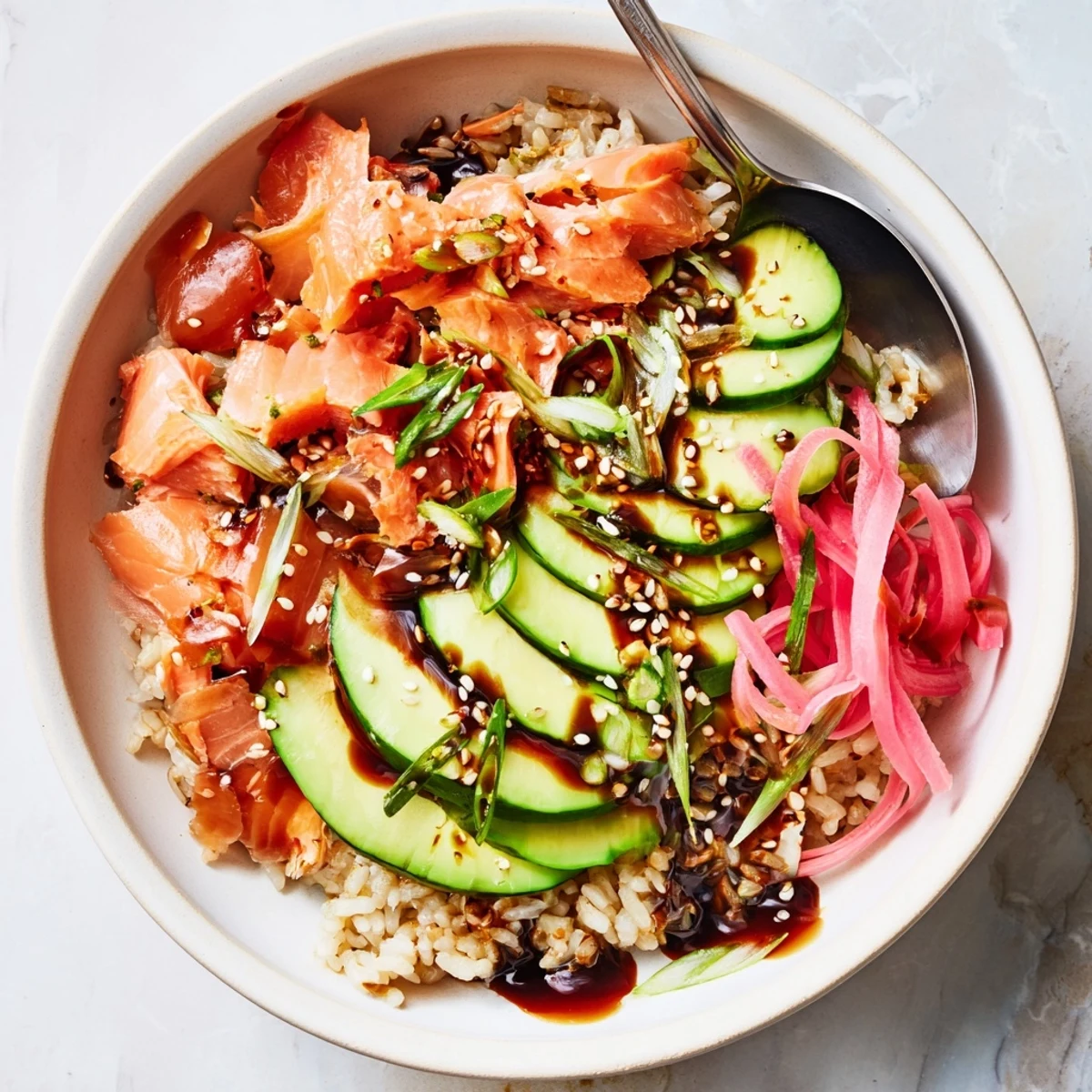 Quick and easy Leftover Salmon & Rice Bowl, drizzled with soy sauce and sesame oil.  