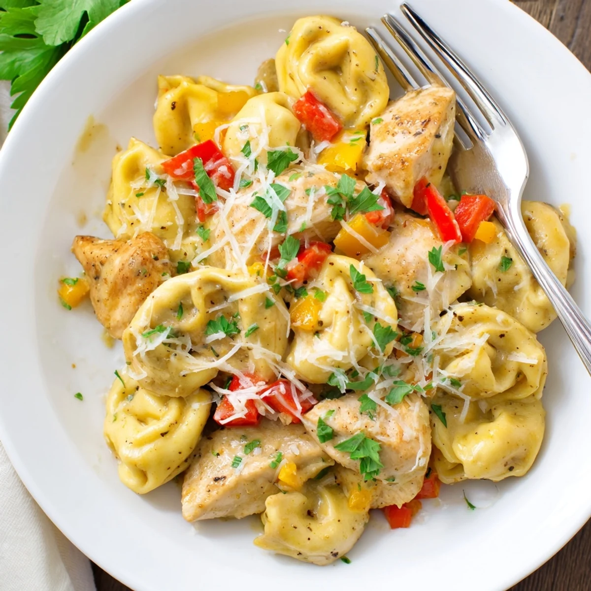 A deliciously vibrant bowl of Zesty Cajun Garlic Parmesan Chicken Tortellini ready to serve.  