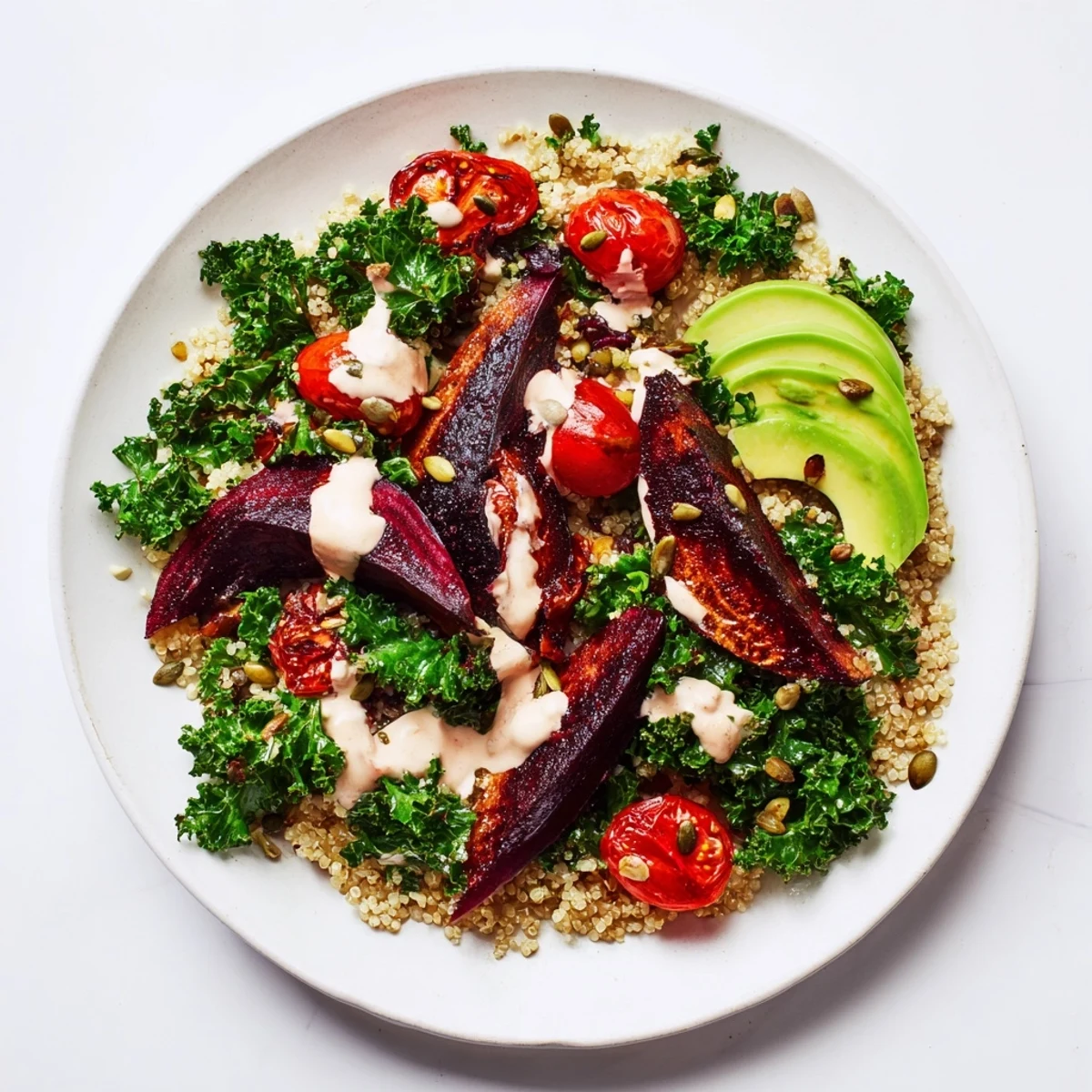 A creamy tahini dressing drizzled over a hearty Quinoa, Kale & Roasted Beet Bowl, ideal for a light meal.