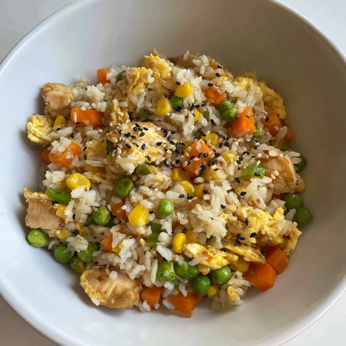 The golden-brown, flavorful Frozen Veggie Fried Rice is flecked with green onions and sesame seeds; a simple weeknight dinner.