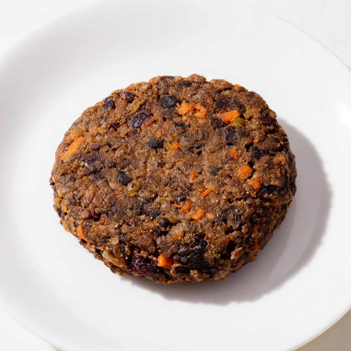 Golden-brown, pan-fried black bean burgers ready to stack with fresh lettuce, tomatoes, and buns.