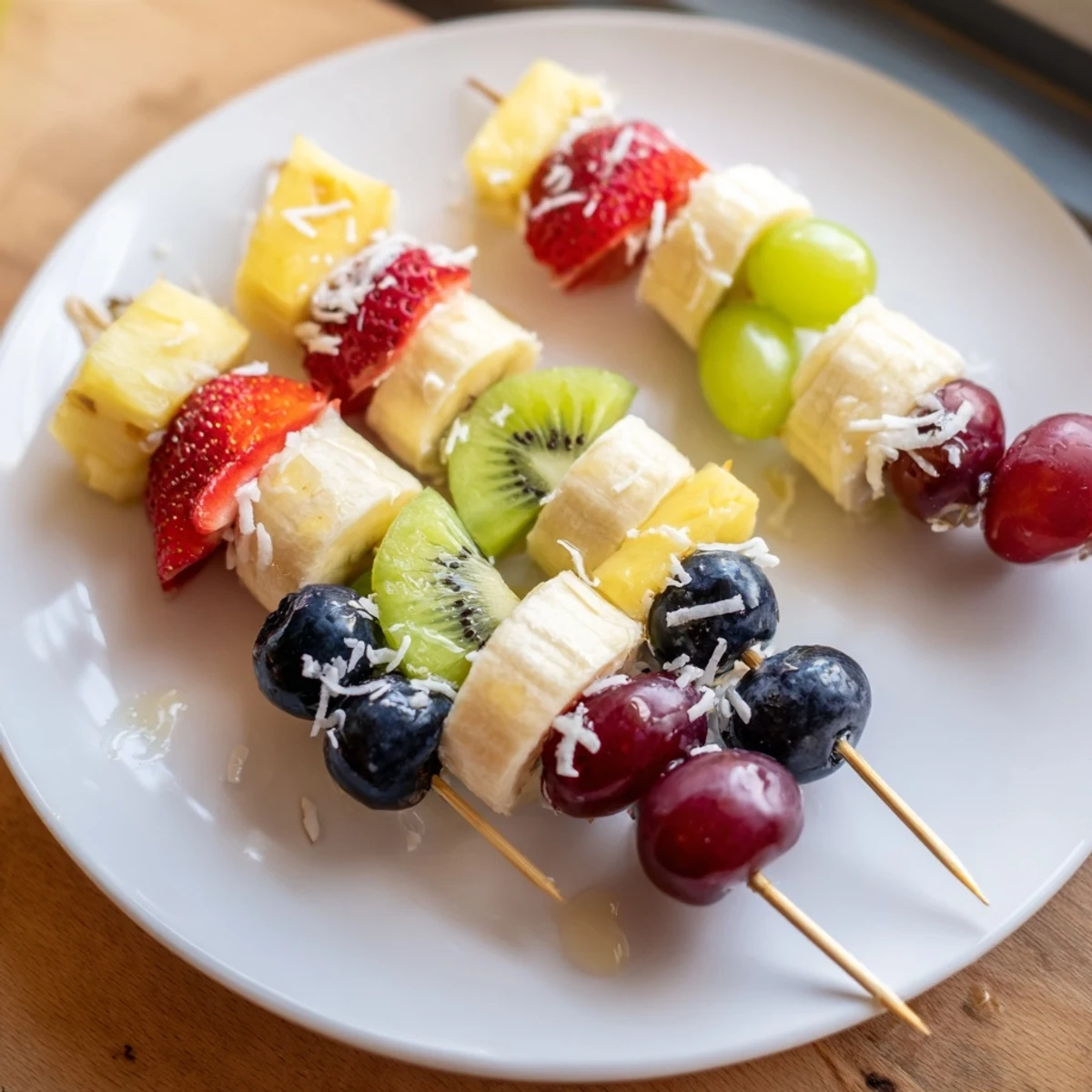 Vivid close-up: A platter of colorful easy festive fruit kabobs with glistening honey drizzle.