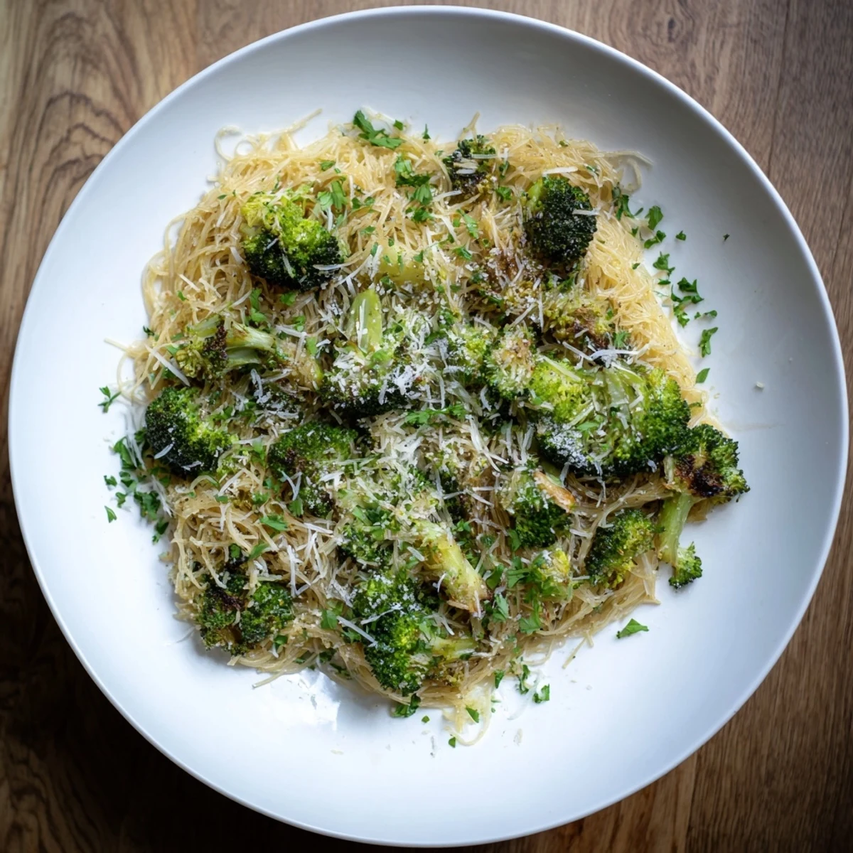 Golden roasted garlic lemon broccoli angel hair pasta, glistening with lemon and Parmesan.