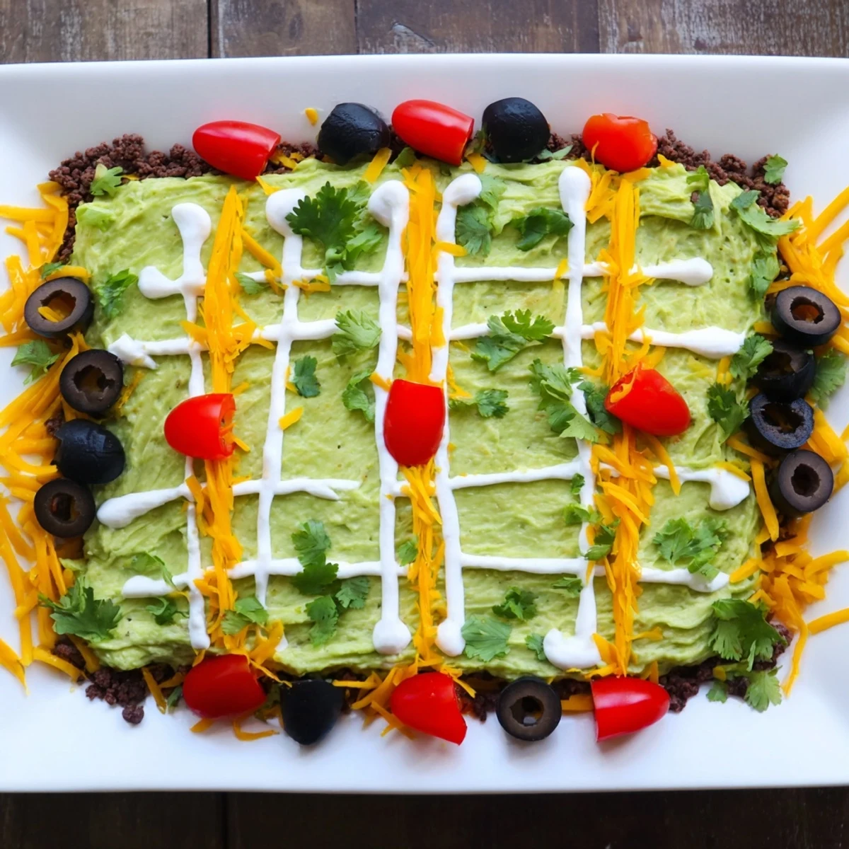 A fun "Soccer Field Nacho Platter" is layered with savory beef, creamy salsa, and a winning game day presentation.