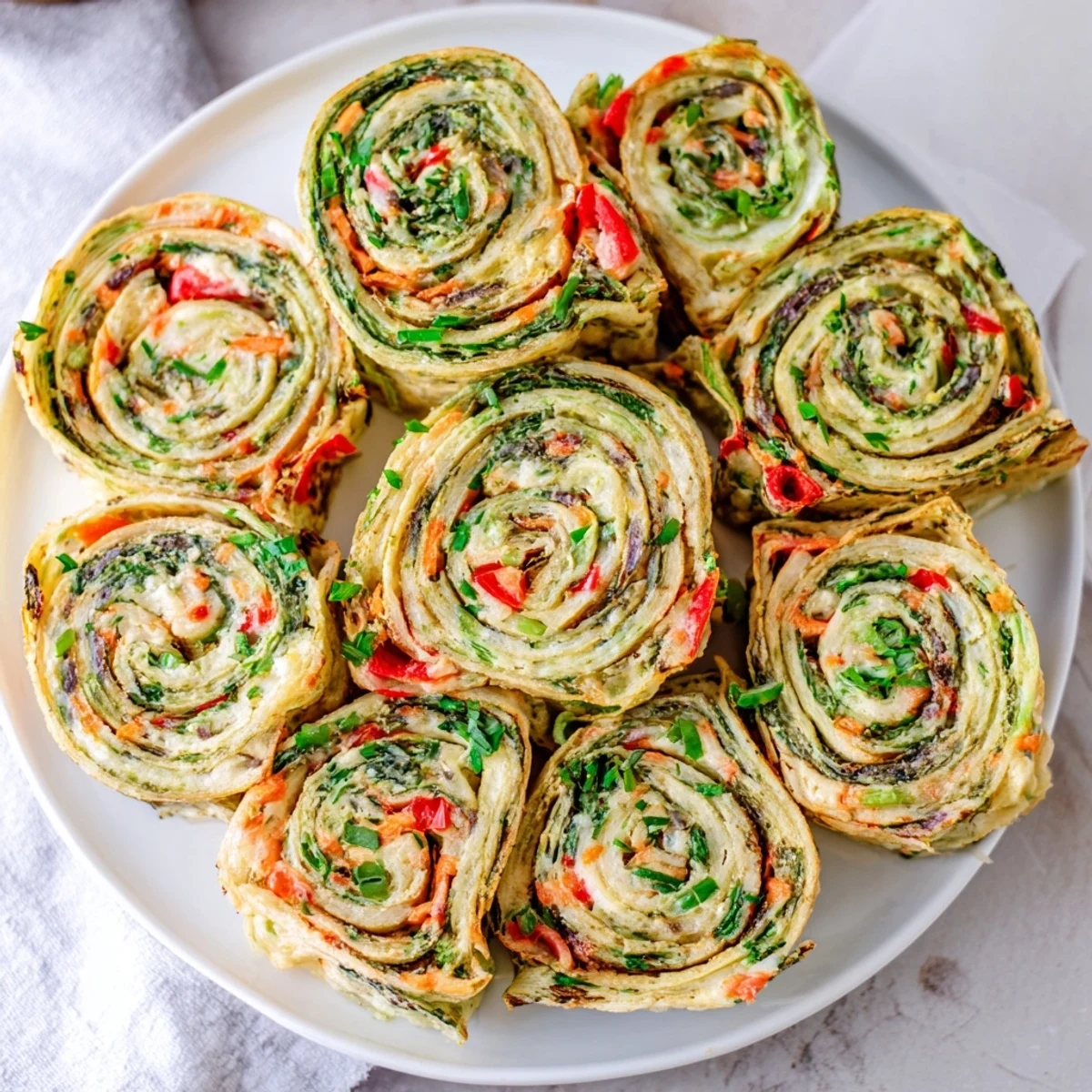 Cozy Scarf Holiday Pinwheel Wraps: Colorful spirals of fresh spinach tortilla, filled with savory cheese and veggies.