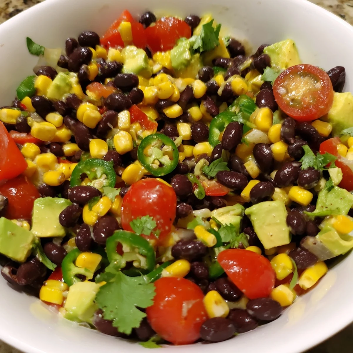Beautifully plated Southwestern Black Bean and Corn Salad featuring avocado, perfect for a light lunch.