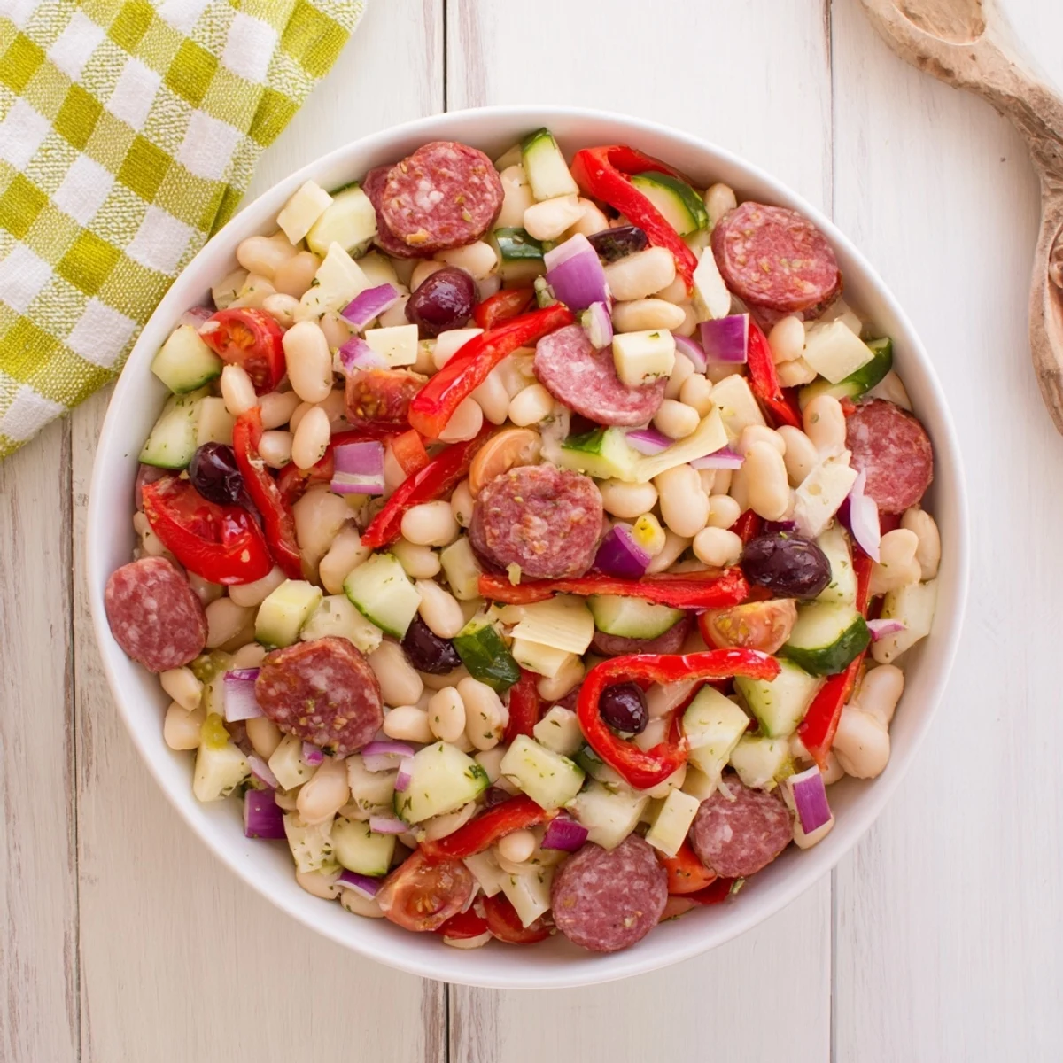 Hearty Italian antipasto bean salad: a colorful mix of beans, salami, and provolone, perfectly dressed.