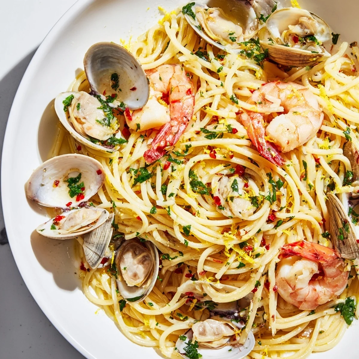 A close-up of Seafood Pasta Aglio e Olio, showcasing perfectly cooked shrimp and al dente spaghetti.