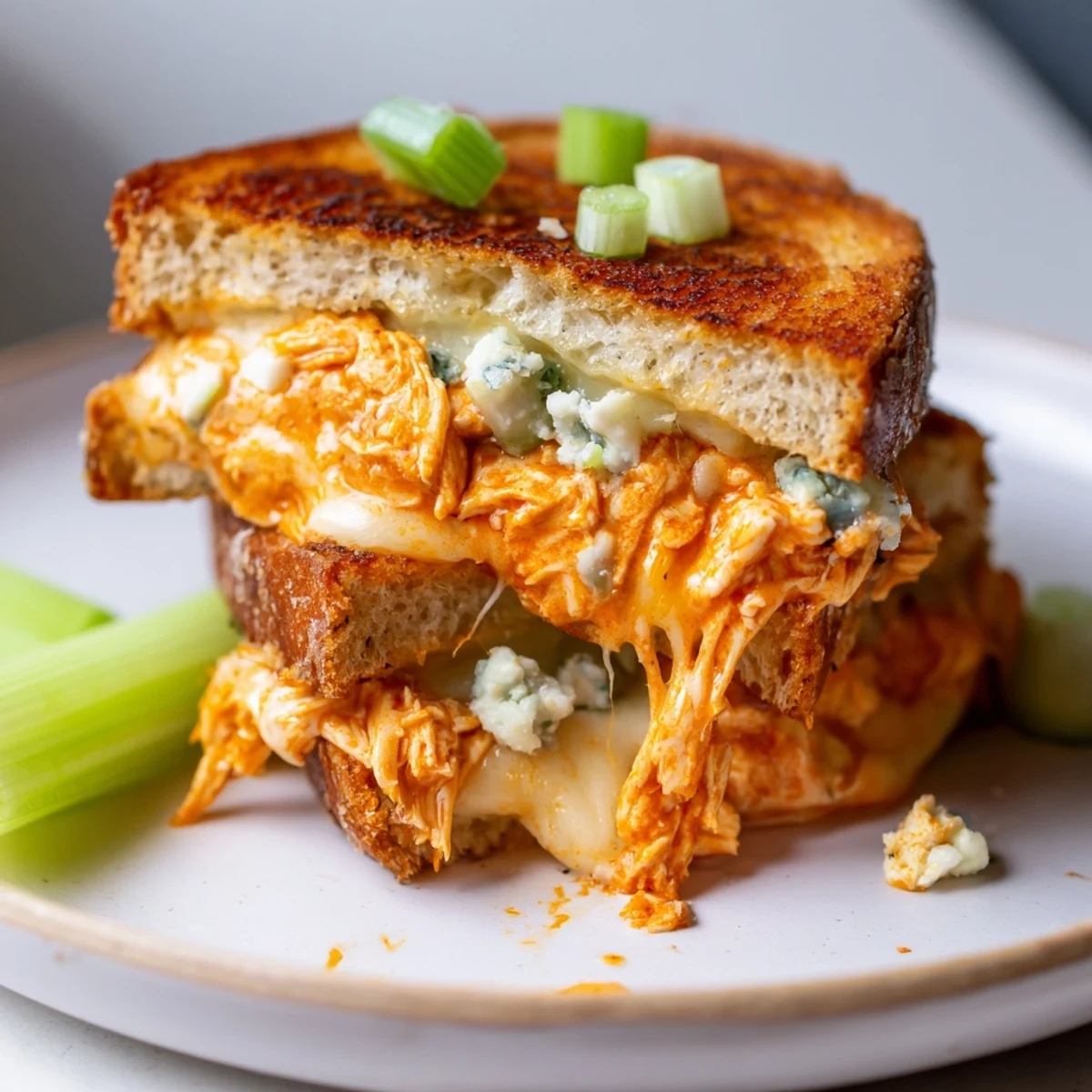 Golden-brown Buffalo Chicken Grilled Cheese oozes with melted cheese, spicy chicken, and crispy bread for a winning family meal.