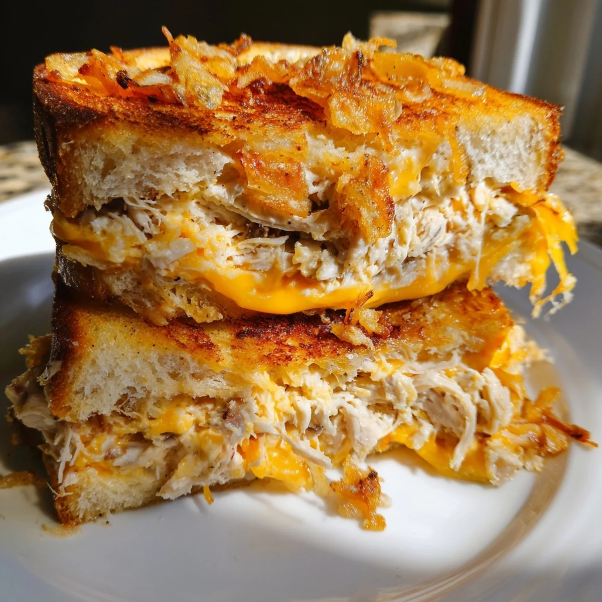 Golden toasted Crispy Shallot Chicken Grilled Cheese with melted cheese oozing out, great for dinner.