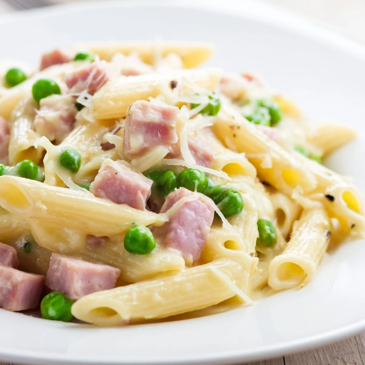 Creamy Spring Pea & Ham Pasta with tender penne, sweet peas, and savory diced ham tossed in a rich Parmesan sauce.