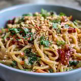 Topped with sesame seeds and served with lime wedges for a bright citrus finish.