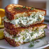 Elegant Mothers Day tea party sandwiches with lemon butter and cucumber slices, perfect for a spring gathering.