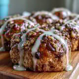 Soft, golden hot cross buns dotted with currants and topped with a fragrant orange glaze.