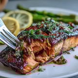 Succulent salmon fillet glazed with zesty lemon and fresh dill, paired with tender asparagus for a bright, flavorful meal.  