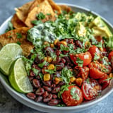 Colorful plant-based taco bowl brimming with black beans and fresh salsa.