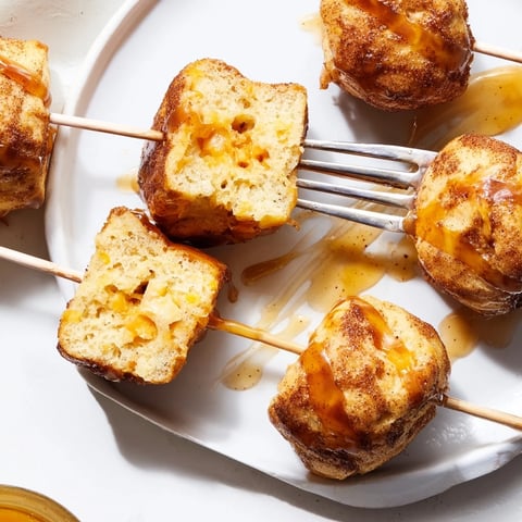 Delicious Cinnamon Sugar Maple Bourbon Cheddar Biscuit Muffin Skewers brushed with warm butter.  