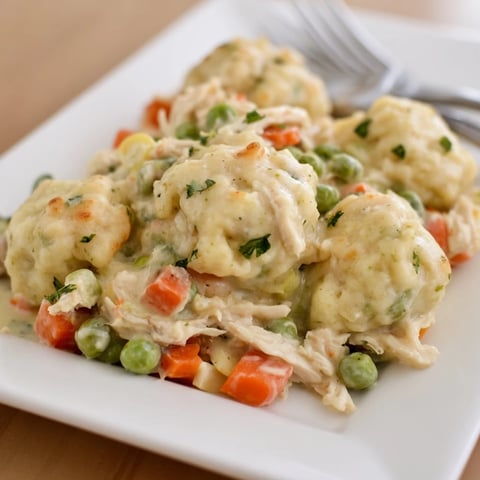 Hearty Chicken and Dumplings Casserole topped with golden, fluffy dumplings fresh from the oven.  