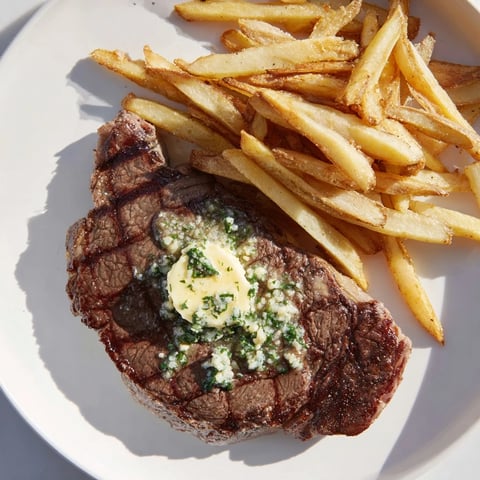 Juicy Steakhouse Garlic Butter Steak & Fries, with glistening garlic butter melting over a perfectly cooked steak.