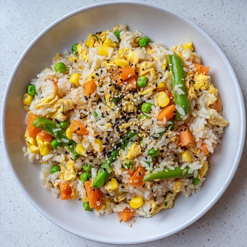 Savory Frozen Veggie Fried Rice showcases fluffy rice with colorful vegetables and scrambled egg, ready to eat.