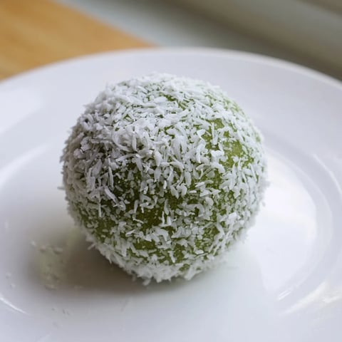 Creamy coconut matcha snowball fat bombs, rolled in coconut, offer a delightful low-carb dessert experience.
