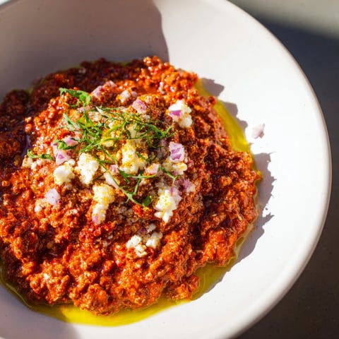 Fiery Volcanic Lava Spicy Dip with a vibrant red hue, ready to be scooped up with chips.