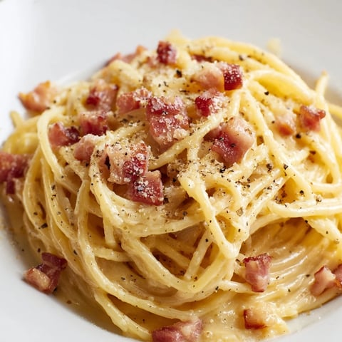 Express Spaghetti Carbonara, a plate of creamy pasta with crispy bacon and grated Parmesan.