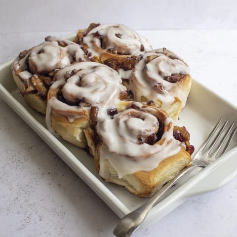 Overhead shot of warm, gooey Apple Cinnamon Rolls, ready to be enjoyed as dessert.