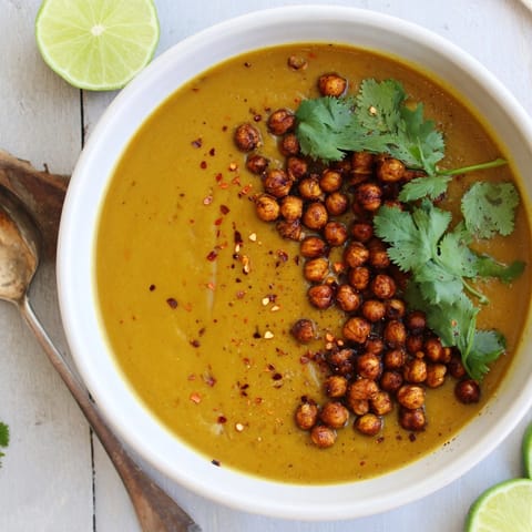 Close-up of flavorful Thai Pumpkin Soup, showcasing the texture and vibrant colors.