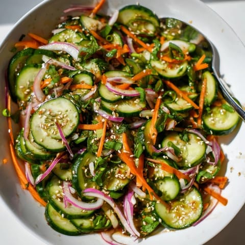 Crisp cucumber salad remix garnished with sesame seeds, perfect as a light appetizer.  