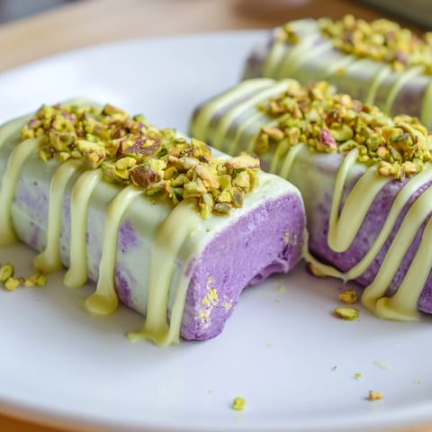Vibrant ube and nutty pistachio ice cream bars drizzled with sweetened condensed milk.  