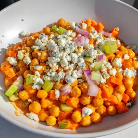 Creamy buffalo chicken bean salad, tossed with blue cheese crumbles, ready to devour.