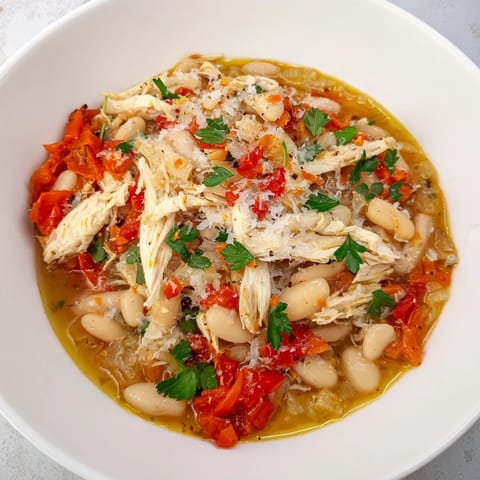 Fragrant stew of White Bean and Roasted Red Pepper Chicken, rustic and hearty, ready to savor.