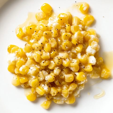 A warm, creamy and irresistible close-up showcasing glistening Honey Butter Skillet Corn with hints of char.