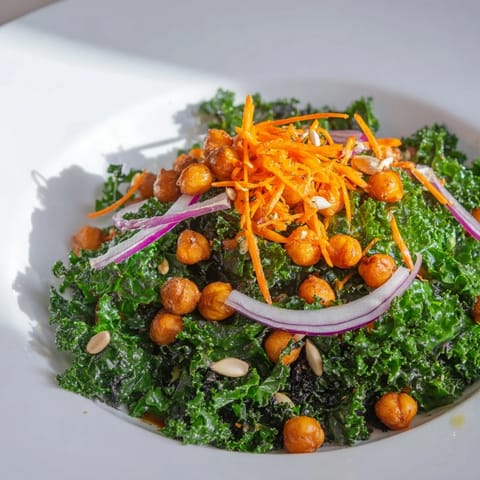 A close-up of a Kale Salad with Roasted Chickpeas shows a colorful, healthy vegan meal.