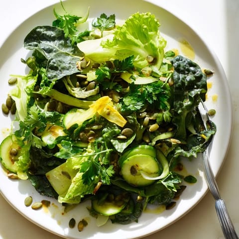 Bright, crisp Glowing Green Salad with mixed baby greens, cucumber, celery, bell pepper, zucchini, and fresh parsley tossed in a zesty lemon vinaigrette.  
