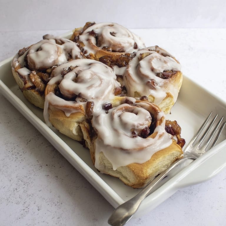 Overhead shot of warm, gooey Apple Cinnamon Rolls, ready to be enjoyed as dessert.