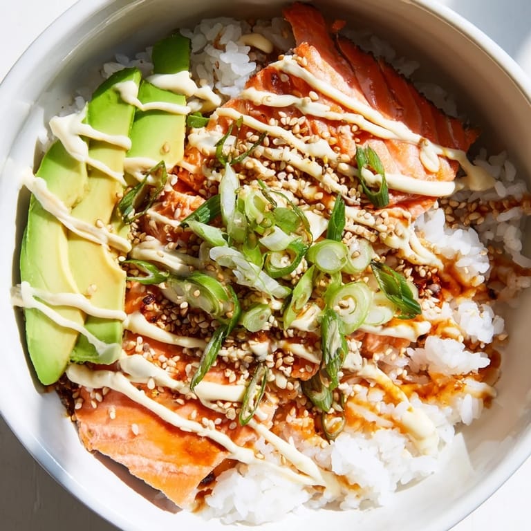 The appetizing Classic Salmon Rice is served with avocado and seaweed, creating exciting flavors in every bite.