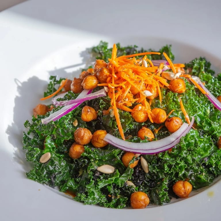 A close-up of a Kale Salad with Roasted Chickpeas shows a colorful, healthy vegan meal.