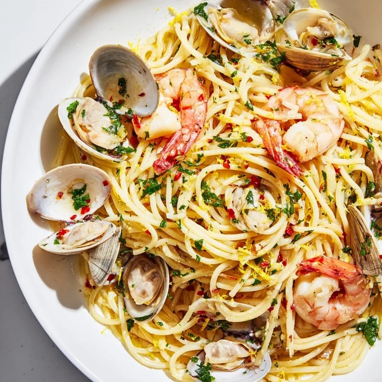 A close-up of Seafood Pasta Aglio e Olio, showcasing perfectly cooked shrimp and al dente spaghetti.