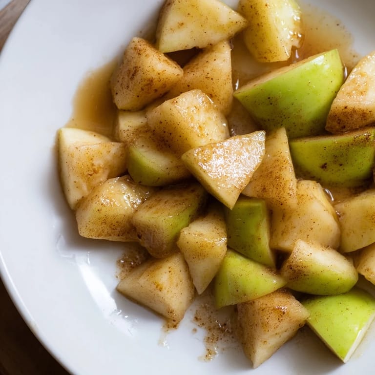 Golden, glistening slow cooker stewed apples with cinnamon, ready to top your morning yogurt.