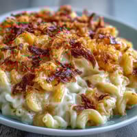 Creamy mac and cheese bake with golden panko topping and bubbling cheddar sauce, served hot from the oven.